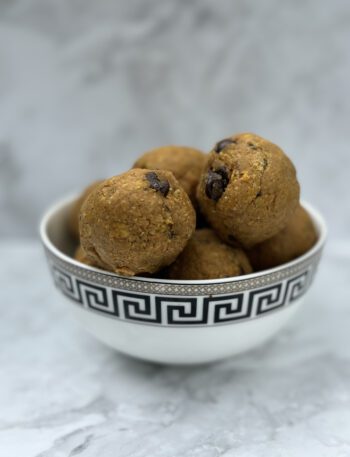 a bowl full of pumpkin and chocolate oat balls.