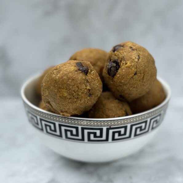 a bowl full of pumpkin and chocolate oat balls.