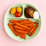 A plate full of carrot fries is shown.
