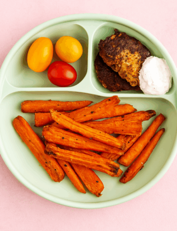 A plate full of carrot fries is shown.