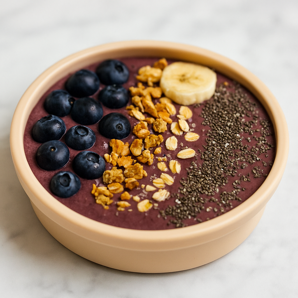A first acai smoothie bowl for kids is shown topped with berries, nuts, and seeds.
