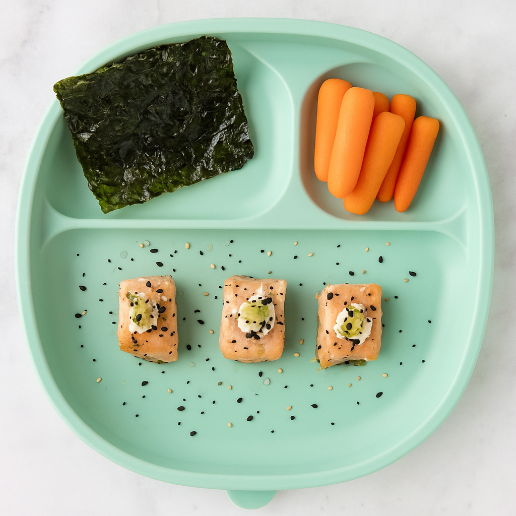 salmon bites for toddlers--flavored like an everything bagel--are shown on a plate with carrots and seaweed.