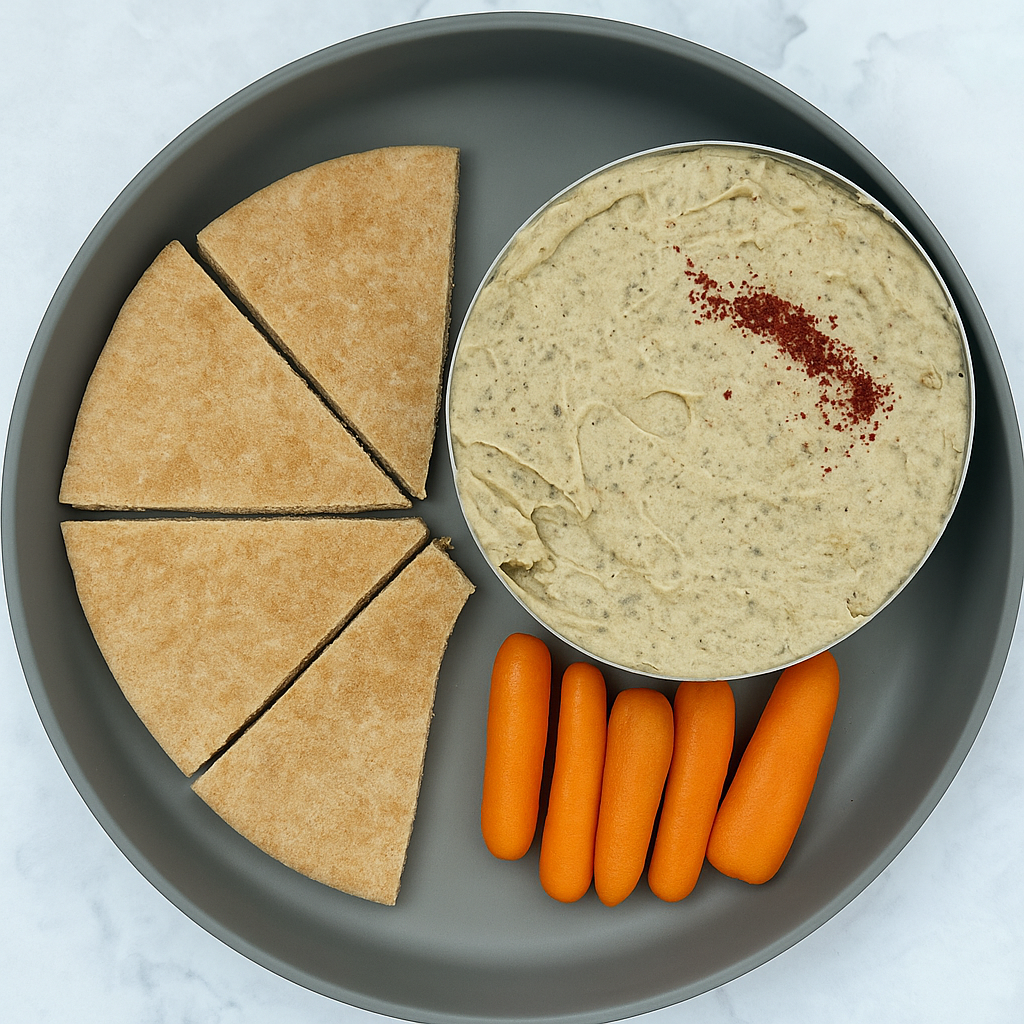 Baba ghanoush for babies, here plated with pita and baby carrot sticks.