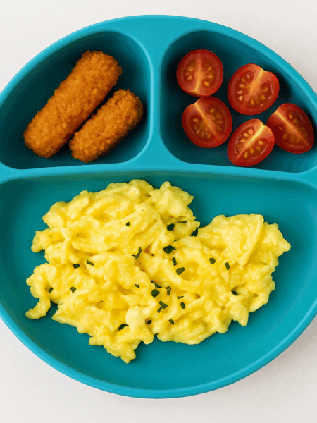 A plate filled with scrambled eggs made with cottage cheese.