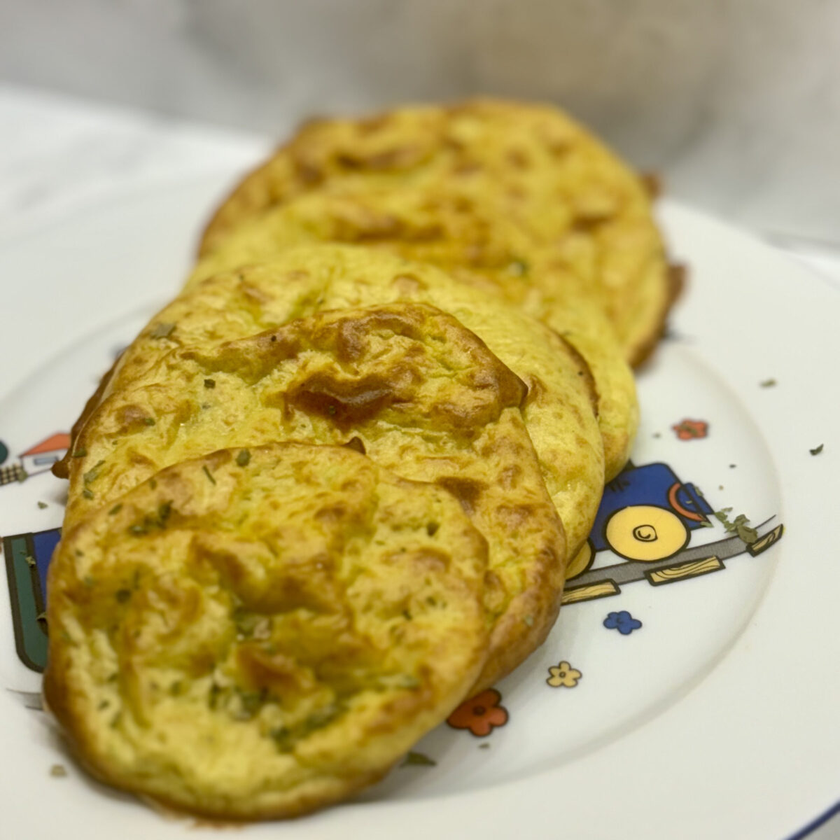 A stack of cottage cheese and avocado flatbread is lined up on a plate.