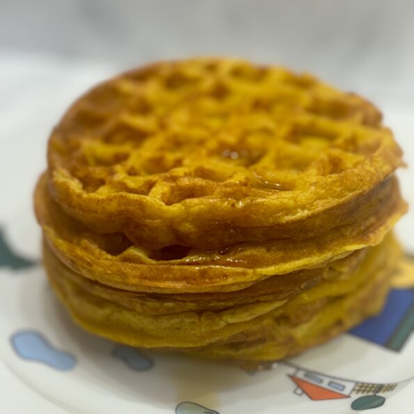 A stack of squash waffles tower over its plate.