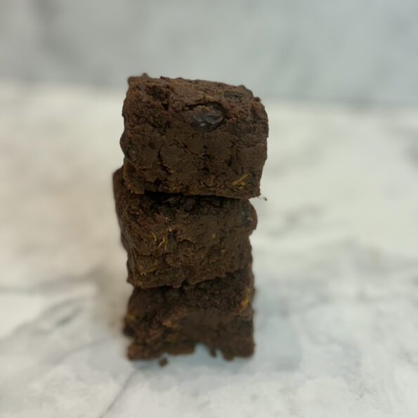 A stack of sweet potato and black bean chocolate brownies stands tall on a counter.