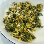 A pile of Goldfish-crusted broccoli bites sits in a bowl.