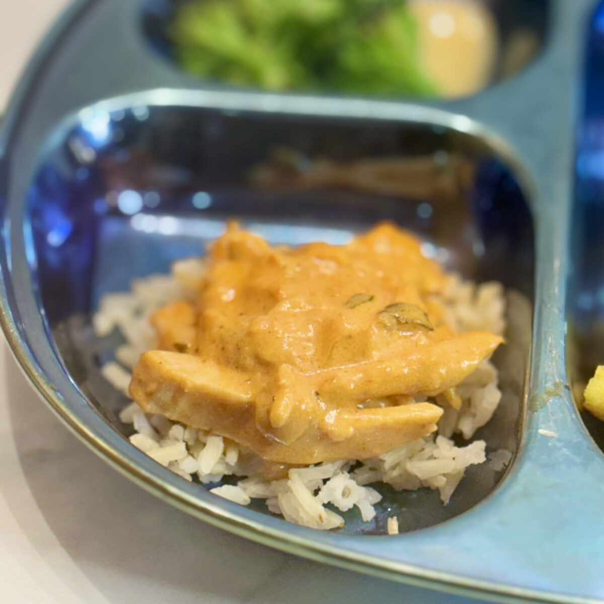 Brazilian style chicken stroganoff sits atop rice.