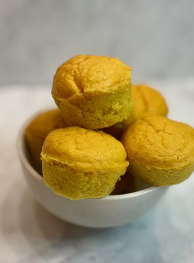 A bowl full of toddler protein muffins is displayed.