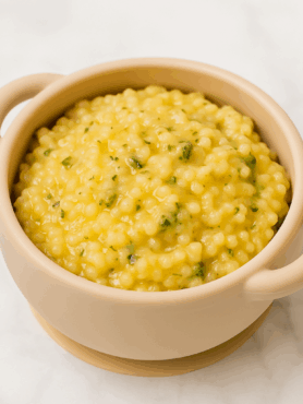 Pastina, here flavored with broccoli and cheddar, as served in a toddler bowl.