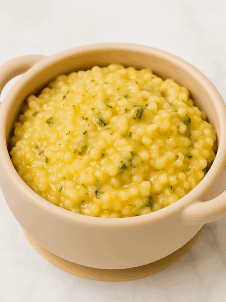 Pastina, here flavored with broccoli and cheddar, as served in a toddler bowl.