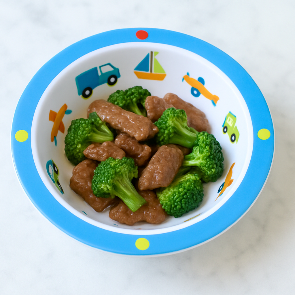 Toddler beef and broccoli presented in a small ramekin, with pieces of steak and broccoli intermingling.