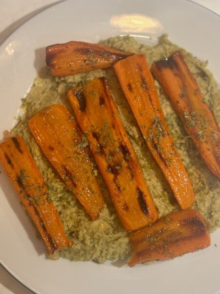 Carrots for toddlers: honey and roasted orange carrots are strewn atop a whip of chickpeas and herbs.