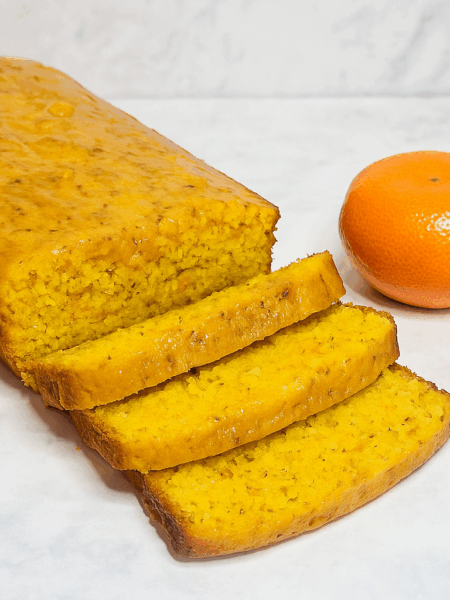 A sliced loaf cake comprised of whole clementines in shown.