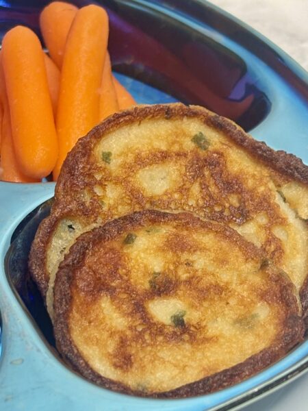 Turn leftover mashed potatoes into a winning toddler side by forming them into a pancake and frying them up.