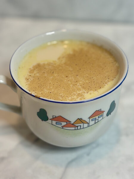 Close-up of a cup of this toddler sleep aide tea, with cinnamon dusted on top of the liquid.