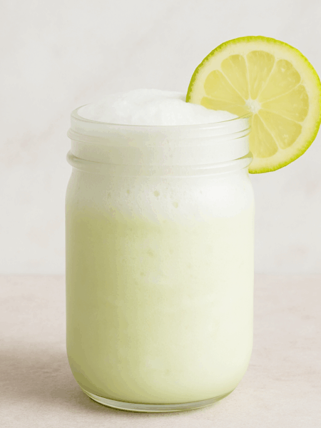 A frothy glass of frozen lemonade for kids is shown.