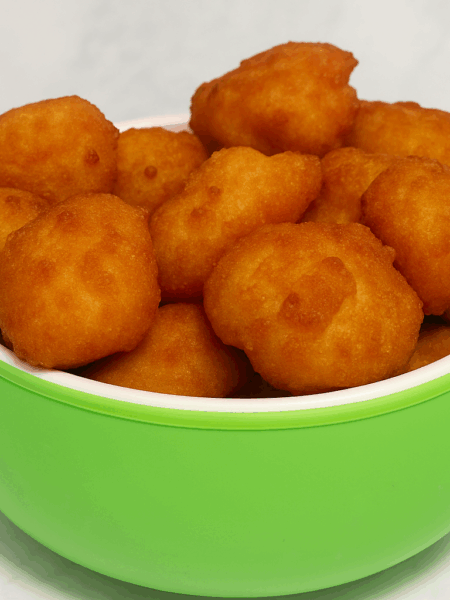 A bowl full of kibbeh, ground beef and couscous croquettes, is displayed,