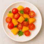 An example of salad for toddlers: slices of peach and grape tomato are enrobed in a very light dressing of oil, vinegar, and cilantro.