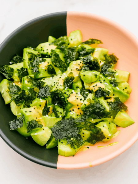 cucumber and avocado salad, topped with soy and mayo dressings and seaweed snacks.