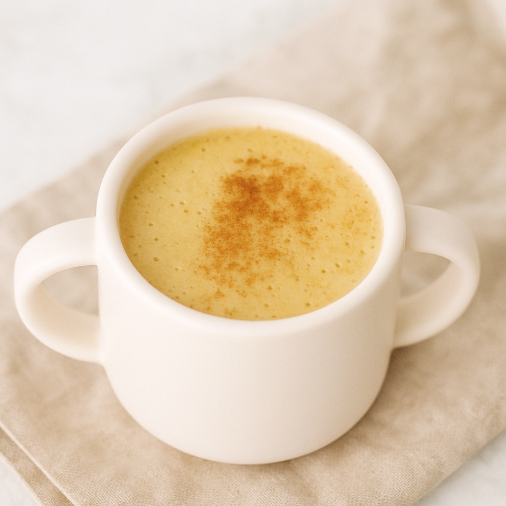 A cup of healthy apple quinoa drink is shown dusted with cinnamon.