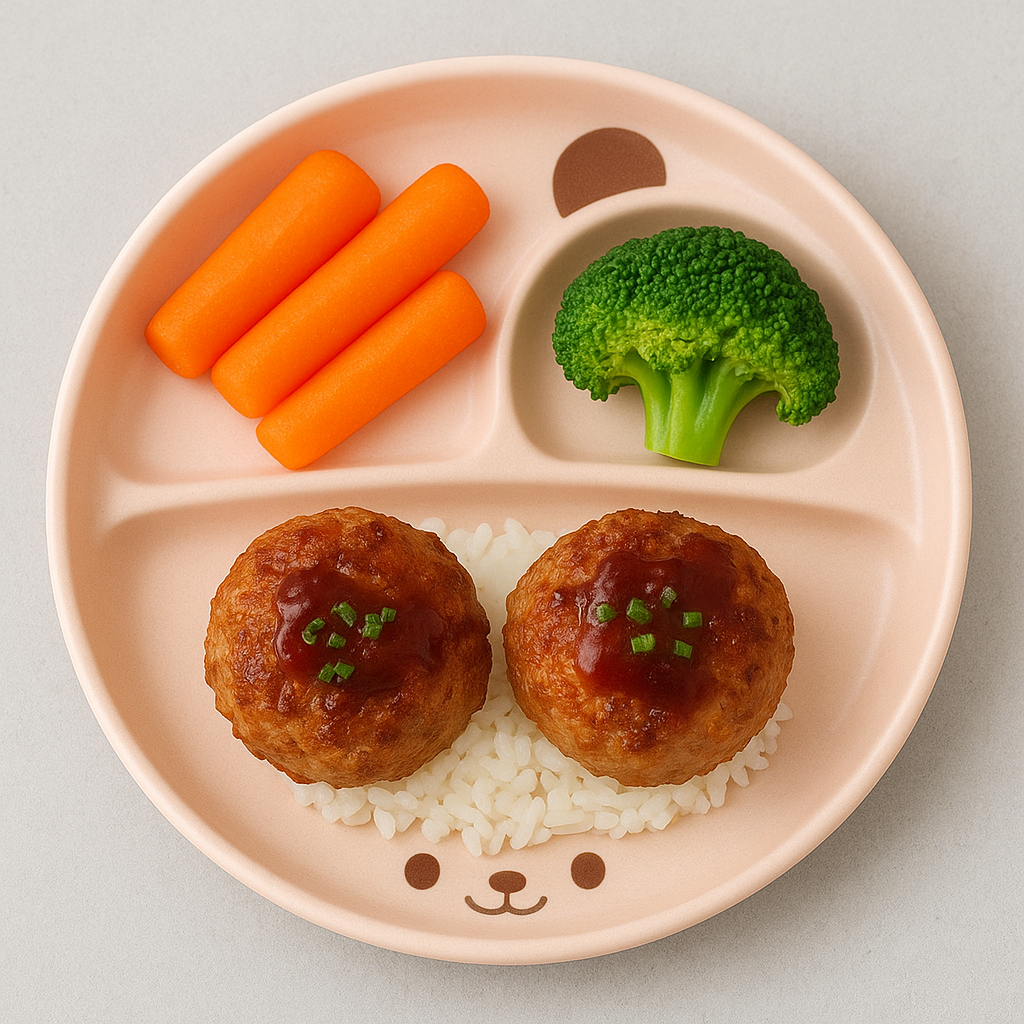 Sample plate of the best meatballs for kids: two lion's head meatballs atop rice, sided by veggies.