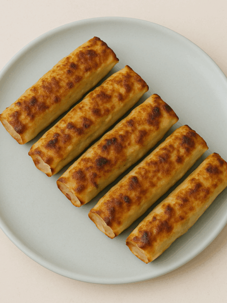 A stack of crispy pork dumplings lay on a plate.