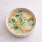 Kid-friendly creamy soup with gnocchi, sausage, spinach, and vegetables in a toddler bowl