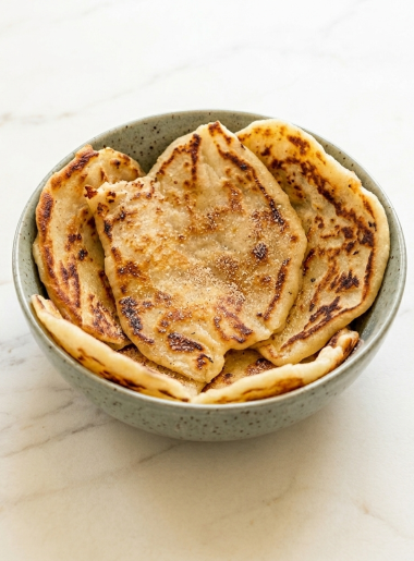 Bowl is filled with small pieces of flatbread made of leftover mashed potatoes.