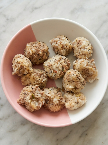 A bowl of toddler-friendly rice balls with ground beef mixed in.