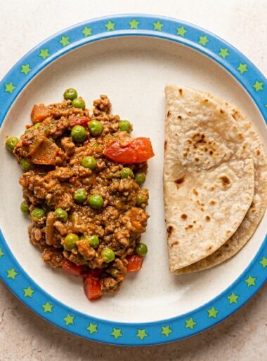 A keema of ground beef with vegetables is shown on a plate alongside chapati bread.